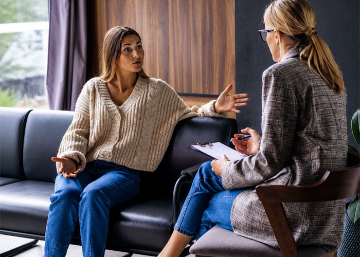 therapist talking to adult patient counseling
